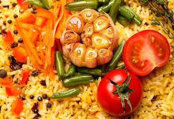Tasty rice pilaf with vegetables as background, closeup