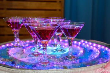 Pile of champagne glasses at a party. Alcoholic luxury pyramid of wineglass.
