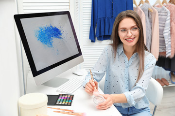 Beauty blogger with brush and highlighter indoors