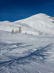 Fototapeta premium Panoramic view of the snowy Alpe Gattascosa in the high Bognanco valley in winter, Piedmont Italy.