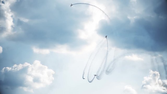 Four fighter jets in the blue sky. A general plan. Aerobatic figures. Airshow. 10 seconds
