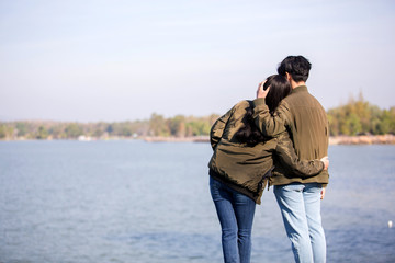 LGBT Asian teenage couples visit the seaside on a clear day and happily show their love for one another.