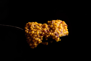 French mustard close-up on a black background.