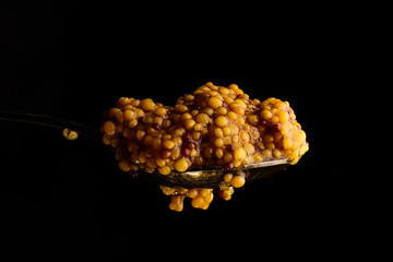 French mustard close-up on a black background.