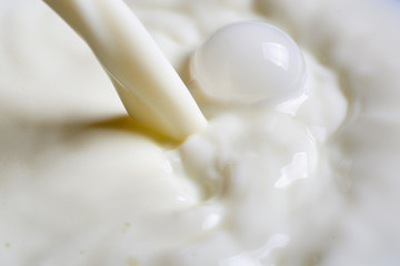 Fototapeta na wymiar Pouring milk or white liquid.