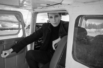 Fototapeta premium Portrait of a man with an airplane on the runway