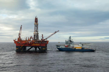  Icebreaker alongside an oil rig in the arctic at Kara Sea Russia.