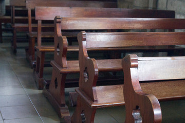 wooden benches in a catholic cathedral