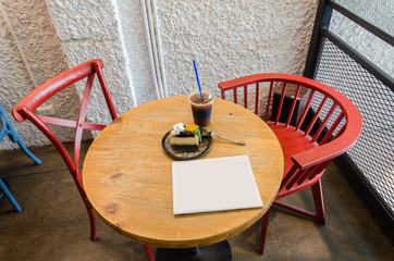 Red chairs and wooden table in coffee shop