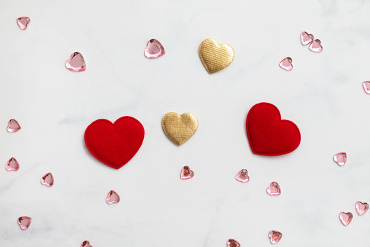 two red hearts and golden hearts on gray background - Powered by Adobe