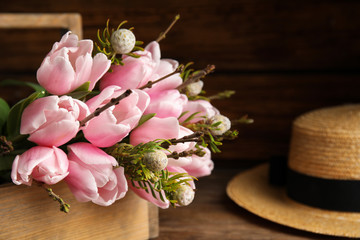 Beautiful bouquet of spring pink tulips on wooden table, closeup
