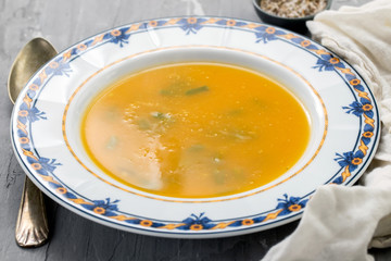 vegetable soup in beautiful dish on ceramic background