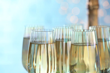 Glasses of champagne on blurred background, closeup