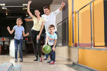 Fototapeta premium Happy family spending time together in bowling club