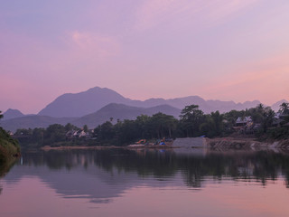River curve with a mountain view in the evening time, a shore is under construction