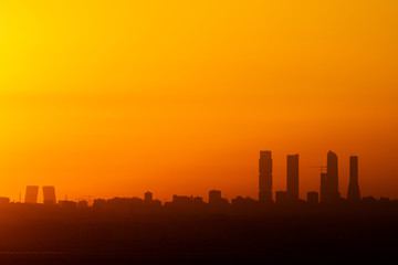 View of Madrid skyline during sunset showing Business Area Towers (R) and Kio Towers (L)