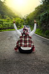 She gave them the finger sitting in the middle of the road that is infinite, surrounded by nature.