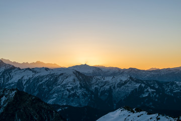 Fototapeta na wymiar Sequences of Sunrise Kedarkantha peak in Uttarakhand Himalayas. Beautiful shots taken from sunrise time lapse during winter trek to Kedarkantha, Uttarkashi (Uttarakhand, India) on New year