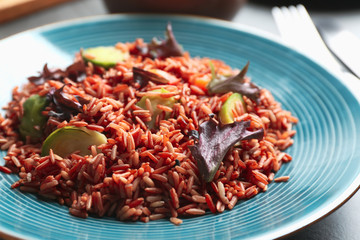 Tasty brown rice with vegetables on table, closeup