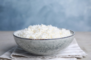 Bowl with tasty cooked rice on table, closeup