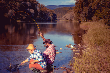 Portrait of cheerful two men fishing. Fly fishing. Perfect weekend. Gone fishing. Weekend time....