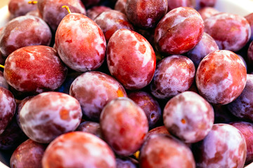 Banner of exotic summer diet. Tropical organic fruit. Plum delivery. Autumn harvest. Stock photo.