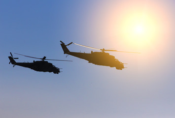 Fototapeta na wymiar military helicopters fly in the blue sky