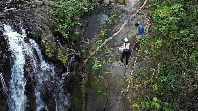 Adventure tourism in tropical Costa Rica while rappelling down a beautiful waterfall  deep in the southern mountains of the country