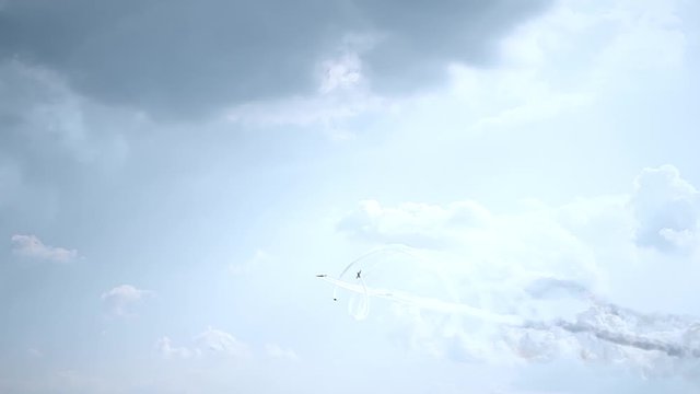 Three fighter jets in the blue sky. A general plan. Aerobatic figures. Airshow. 13 seconds