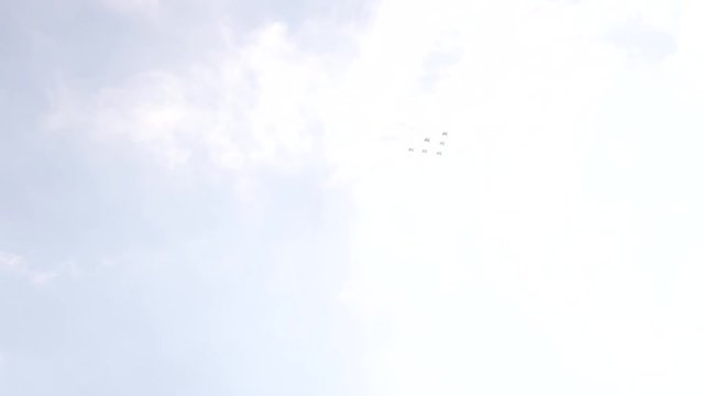 Six fighter jets in the blue sky. A general plan. Aerobatic figures. Airshow. 10 seconds