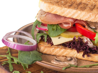 sandwich with ham vegetables and cheese with herbs.