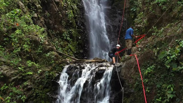Adventure tourism in tropical Costa Rica while rappelling down a beautiful waterfall  deep in the southern mountains of the country