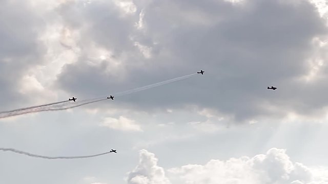 Five fighter jets in the blue sky. A general plan. Aerobatic figures. Airshow. 9 seconds