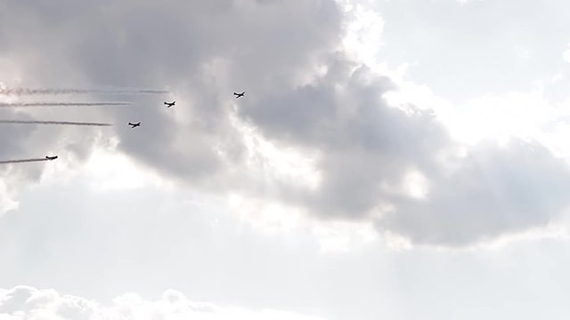 Five fighter jets in the blue sky. A general plan. Aerobatic figures. Airshow. 9 seconds