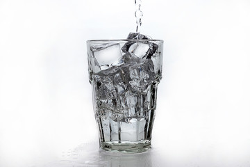 a glass of water with ice isolated on white