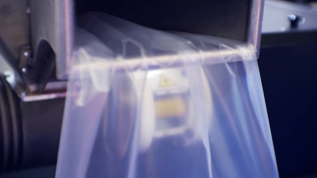 plastic film moves into the pipe of the processing machine.close-up.