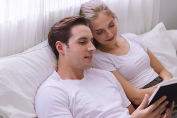 Happy young caucasian couple or lover on bed