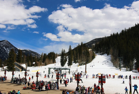 Colorado ski resort vacation concept. Sunny early spring day at Keystone Colorado sky resort. People enjoying outdoor activity during beautiful day. Landscape with mountains covered by snow.