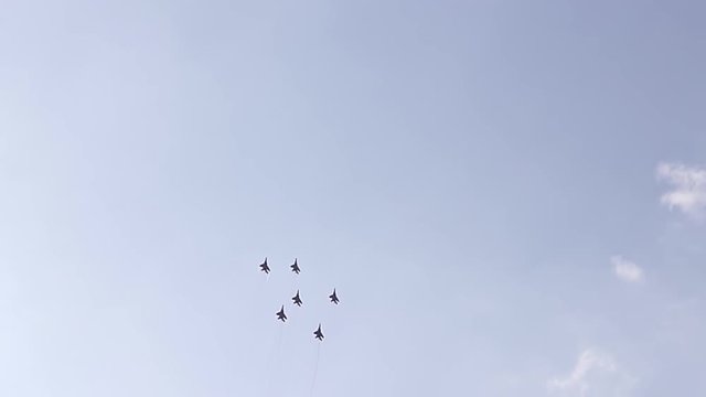Five fighter jets in the blue sky. A general plan. Aerobatic figures. Airshow. 10 seconds