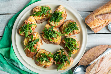 bruscetta with tomatoes, mozzarella and arugula