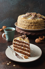 Chocolate cake with bananas decorated with chocolate topping and walnuts.