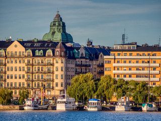 row of boats moored by row of buildings, stockholm