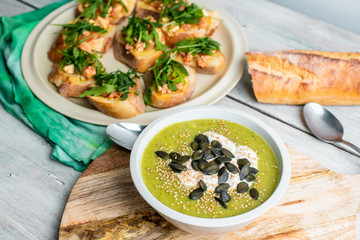 delicious brussel cream soup, next to tasty bruscetta with tomatoes, mozzarella and arugula