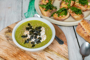 delicious brussel cream soup, next to tasty bruscetta with tomatoes, mozzarella and arugula