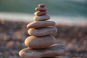 Fototapeta na wymiar Zen concept. Sunset. The object of the stones on the beach at sunset. Relax & Meditation. Zen stones.