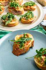 bruscetta with tomatoes, mozzarella and arugula