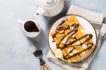 Crepes with chocolate and banana top view.