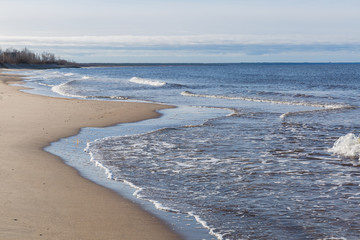 City, Riga, Latvia. Baltic Sea with waves and sand. Travel photo.