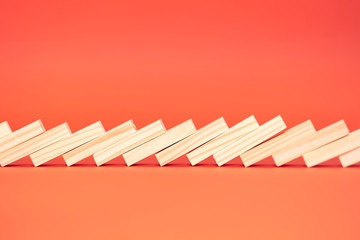 Set of wooden domino. Concept of solution and domino effect. Isolated on red background. Slightly...