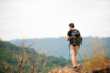 Traveler Hiker with Backpacks walking on top of mountain enjoying the view